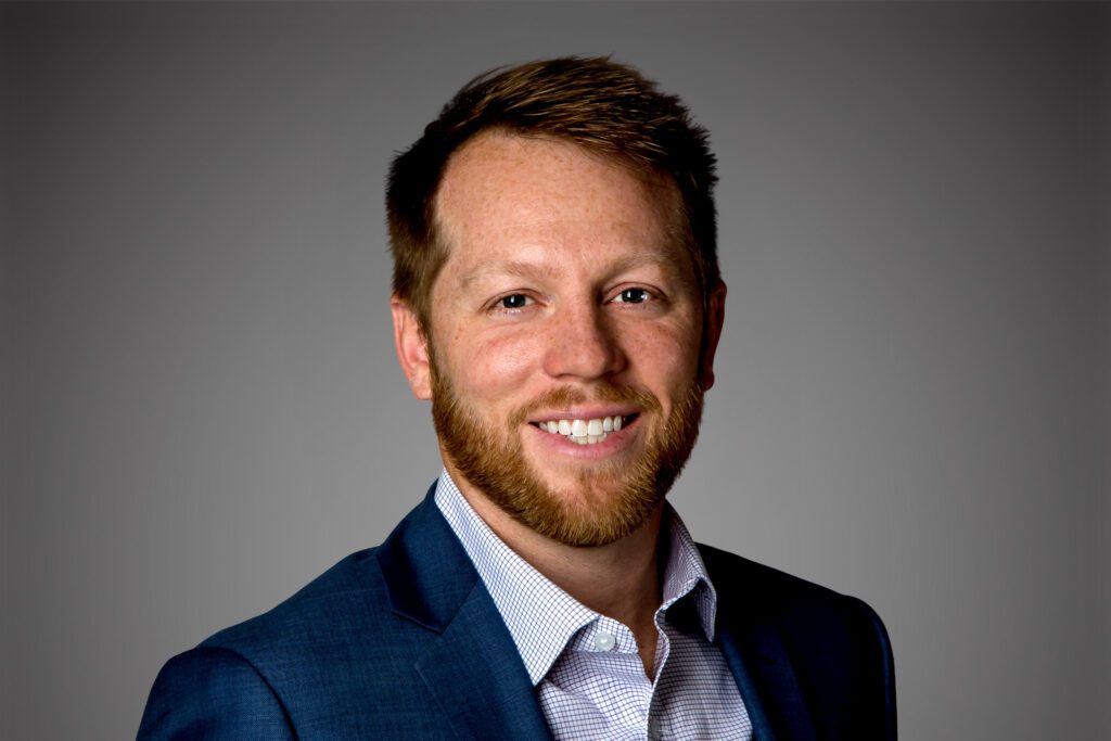 Headshot of Dave Rutledge in front of a gray background.