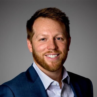 Headshot of Dave Rutledge in front of a gray background.