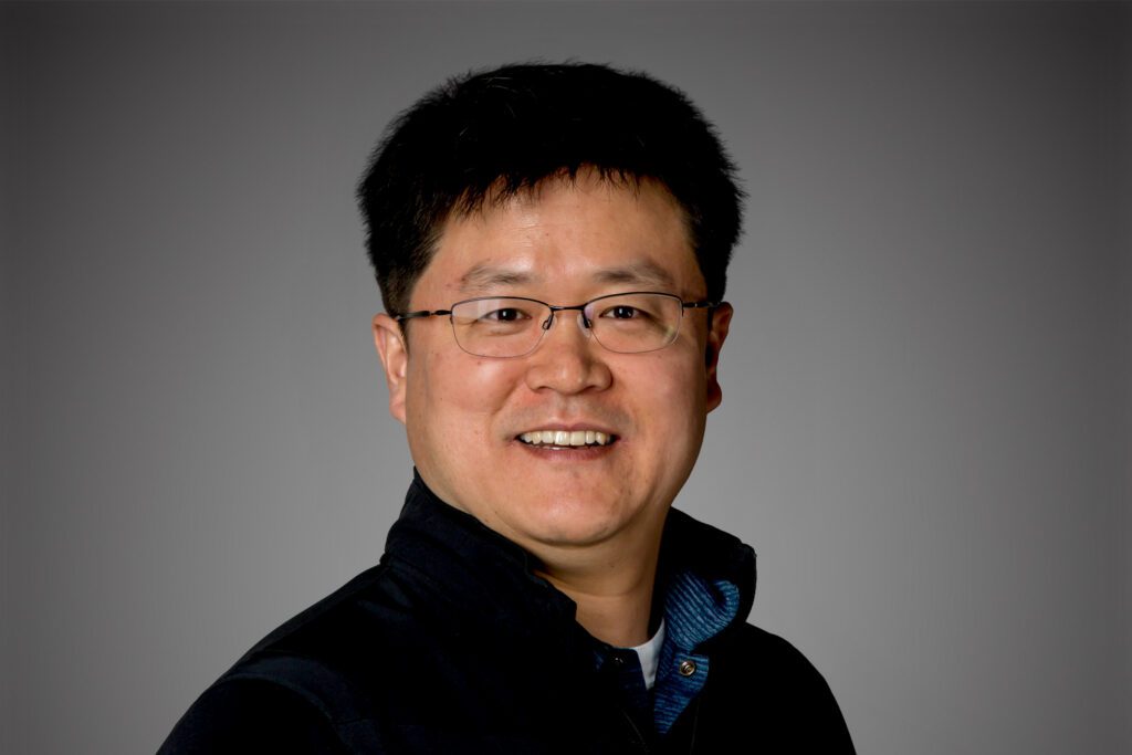 Headshot of Euisang Lee in front of gray background.