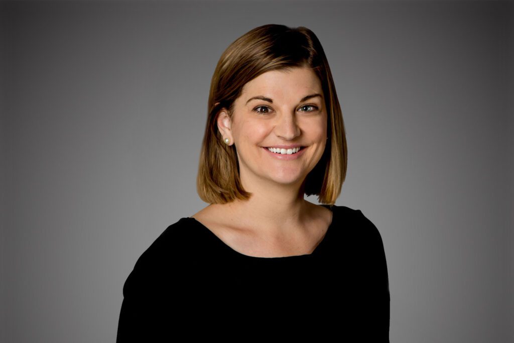 Headshot of Jennifer Stanton in front of a gray background.