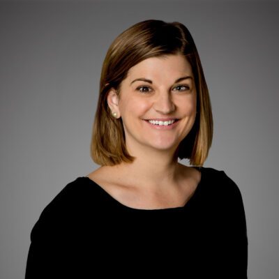Headshot of Jennifer Stanton in front of a gray background.