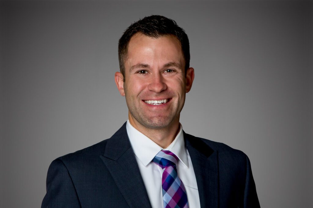 Headshot of Ryan Haase in front of a gray background.