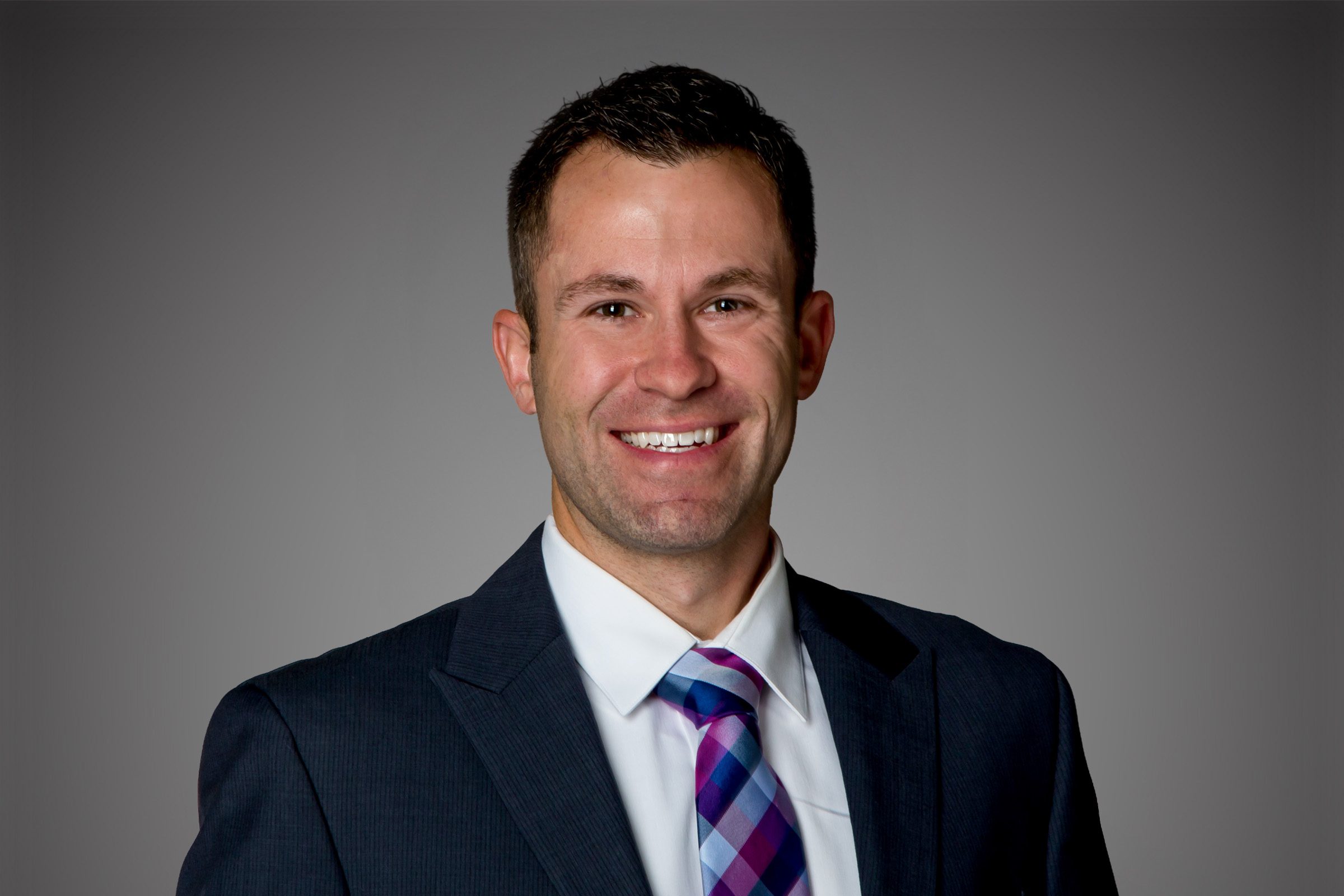 Headshot of Ryan Haase in front of a gray background.