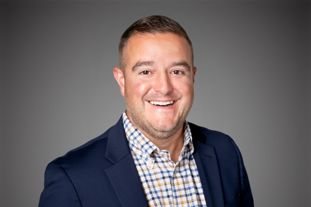 Headshot of Steve Sebastian in front of a gray background.