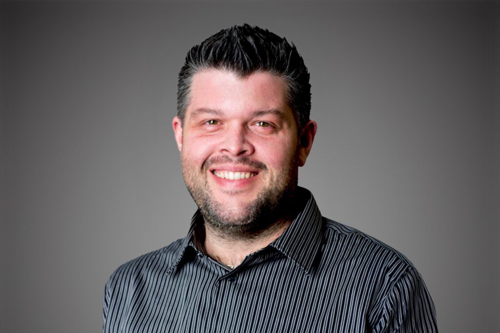 Headshot of Ted Jarosh in front of a gray background.